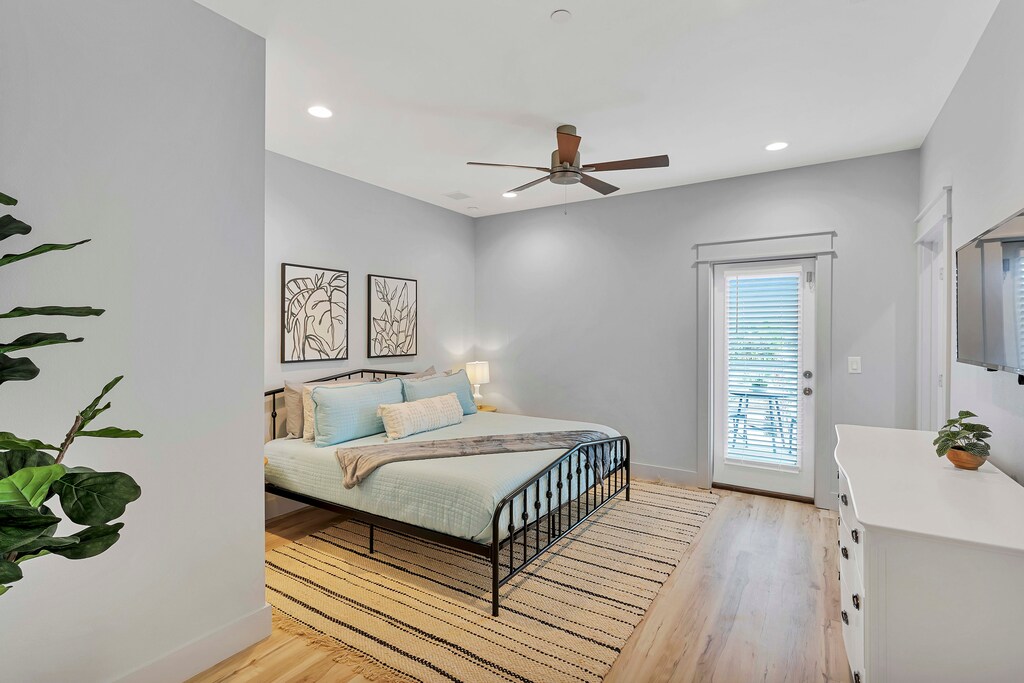 2nd floor tropical Bedroom #3 with a king bed has a mounted flat-screen TV.