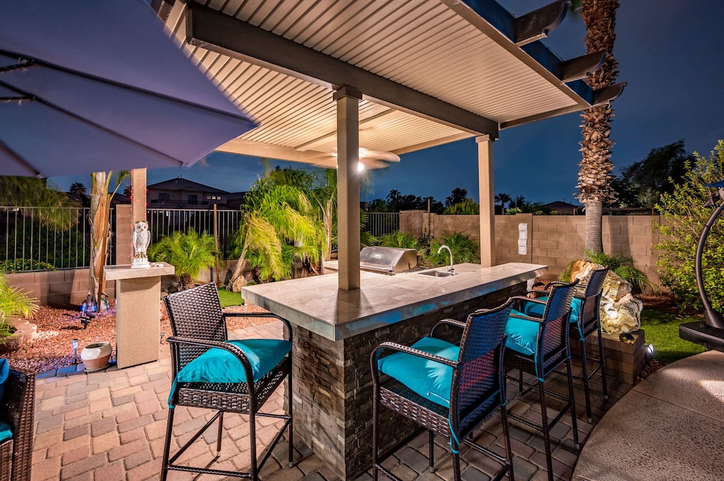 Dine and unwind in style with our outdoor kitchen and high seating—perfect for gatherings!