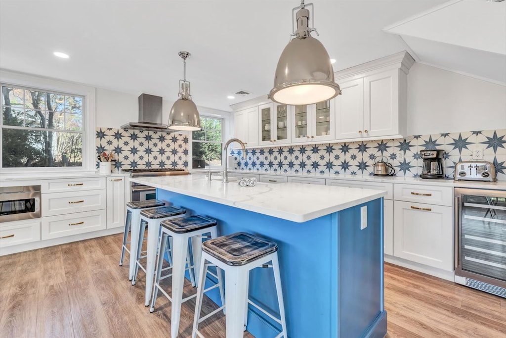 Bright and modern kitchen with a striking blue island, complete with seating for casual dining.