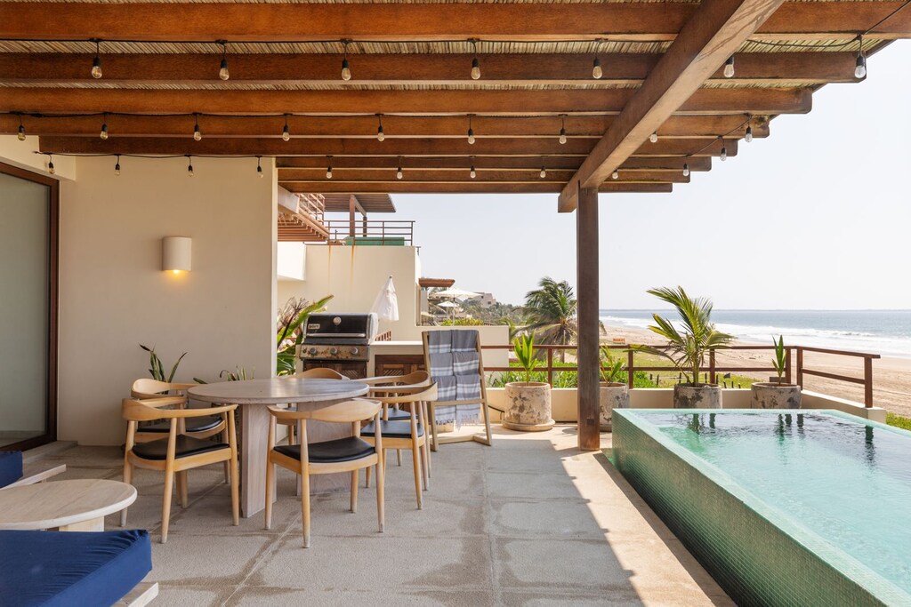 Enjoy the ultimate relaxation on this private rooftop terrace, featuring a plunge pool, outdoor dining, and stunning ocean views.