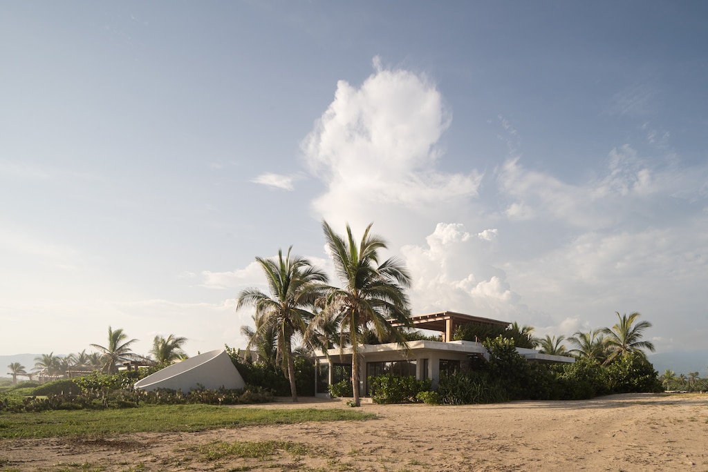 A private coastal retreat surrounded by lush palm trees, offering tranquility and breathtaking sunset views.