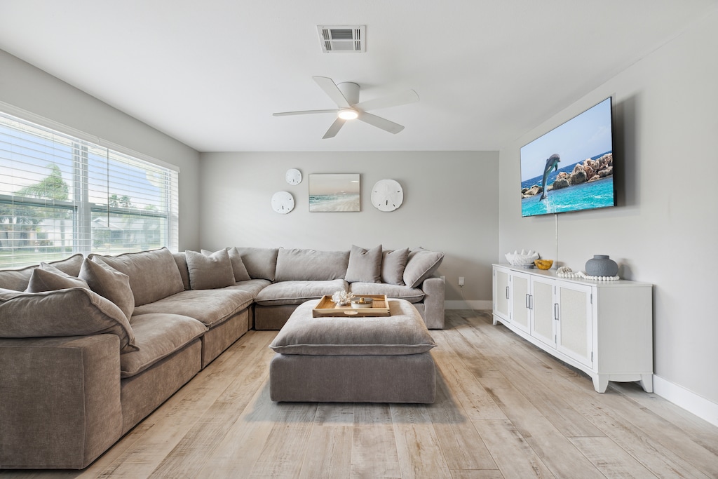 Unwind on a cozy, long sofa while enjoying your favorite shows on a TV!