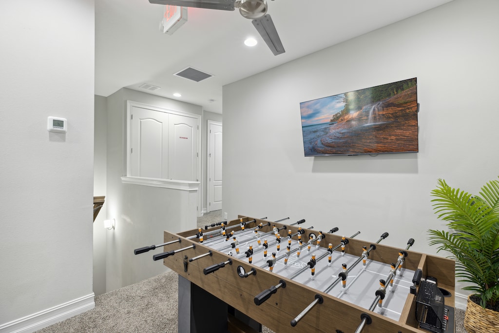 Indoor Game Room with Foosball Table and Wall-Mounted TV