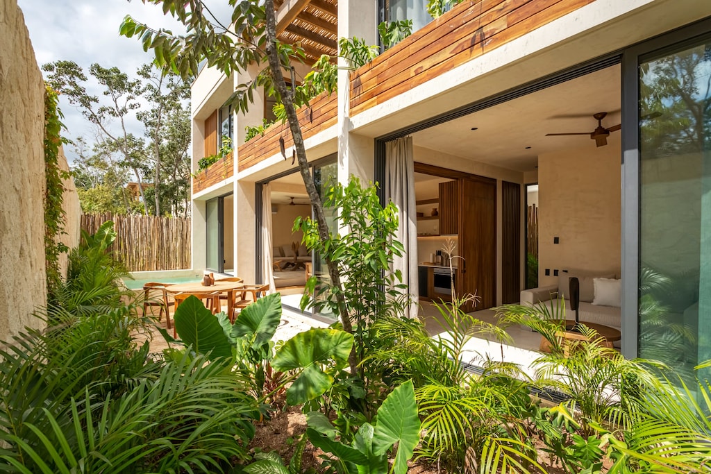 The villa features a fenced garden for privacy and its own private pool.