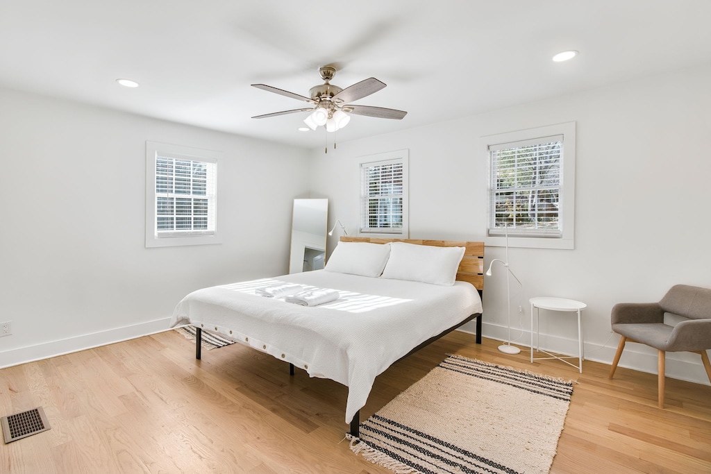Relax in this bright, airy bedroom with a king-sized bed and modern decor, perfect for a restful night's sleep.
