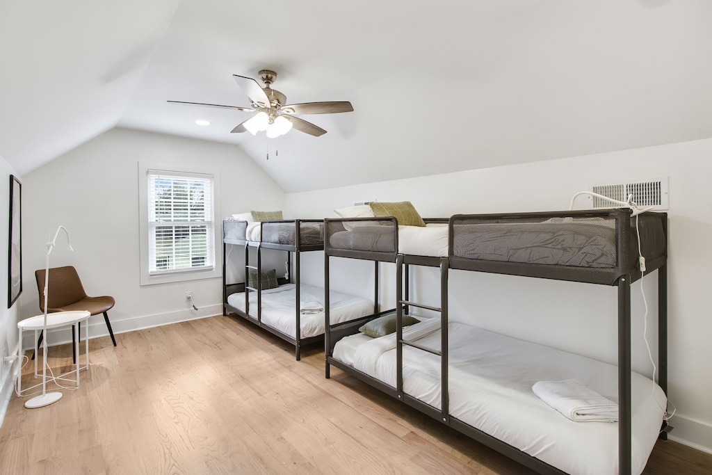 Spacious bedroom with bunk beds, perfect for families or groups, featuring modern amenities and cozy furnishings.