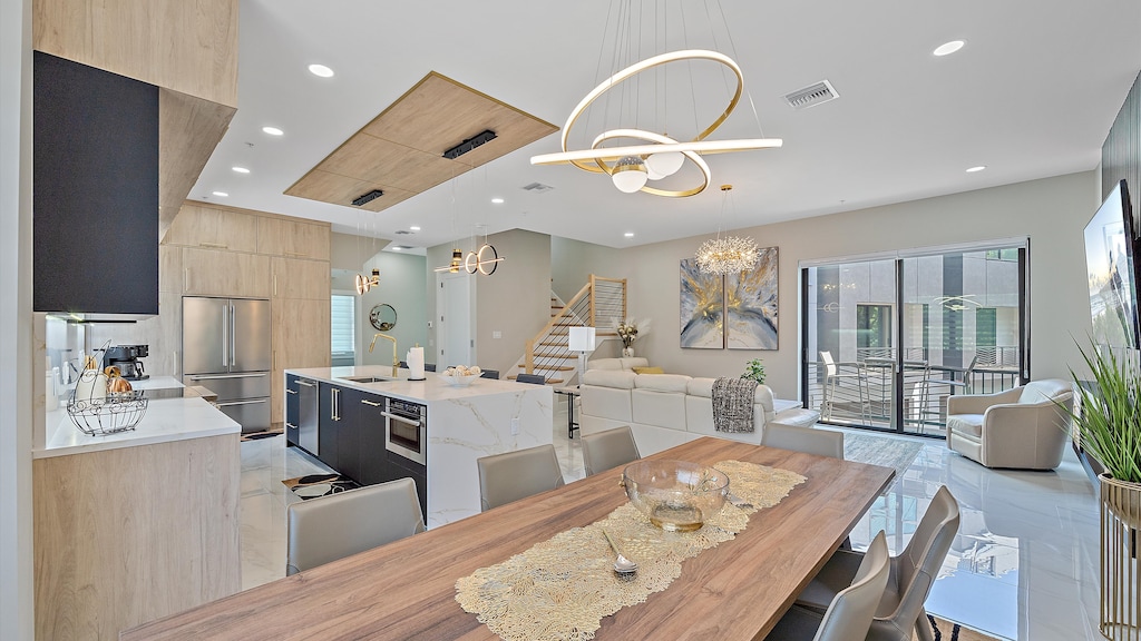 Host family and friends at the elegant dining table, perfectly situated between the gourmet kitchen and cozy living room.