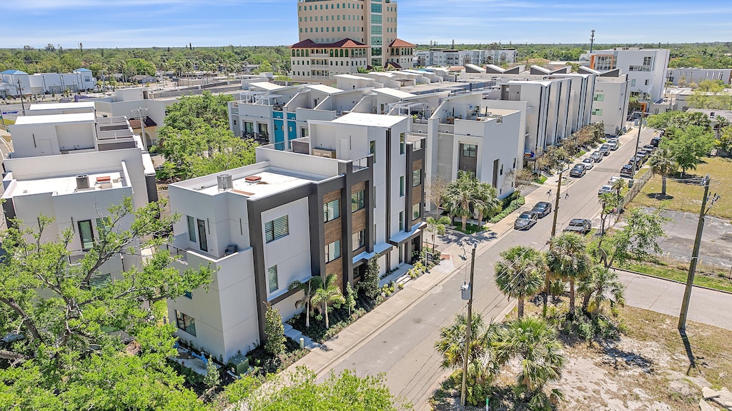 Soak in the incredible aerial view of your stylish townhome complex, highlighting the convenient urban location and modern architecture.