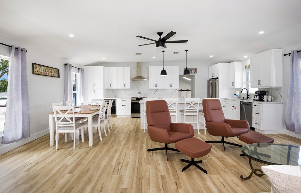 Open concept kitchen leading to living room with two comfy recliner chairs