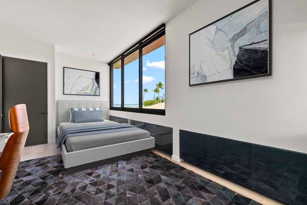 Bright and cozy, this fifth bedroom offers a quiet corner to relax, complete with outdoor views and natural textures.