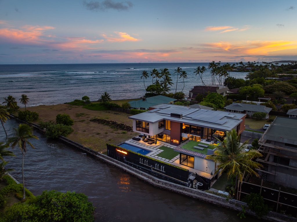 Wake to golden light over the Pacific—Ocean Villa Emilie rests just steps from stunning Oahu coastline.