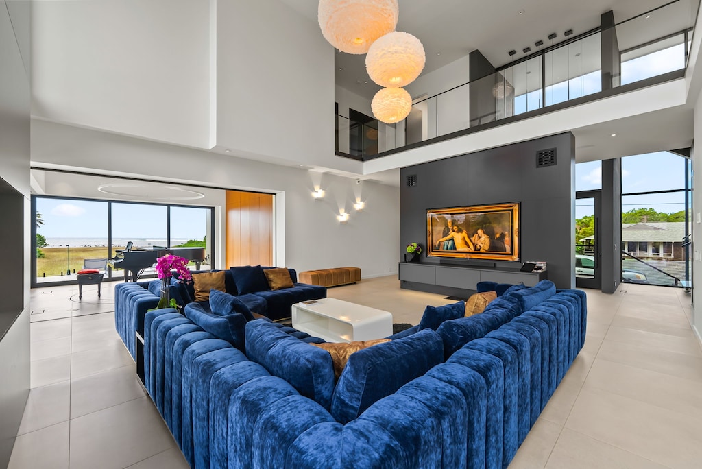 Sink into soft textures in this two-story great room, where island light dances across every carefully curated surface.