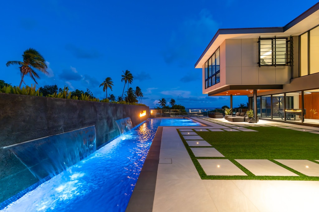 A nighttime stroll along the light-lined lap pool offers serenity under Oahu's stars.