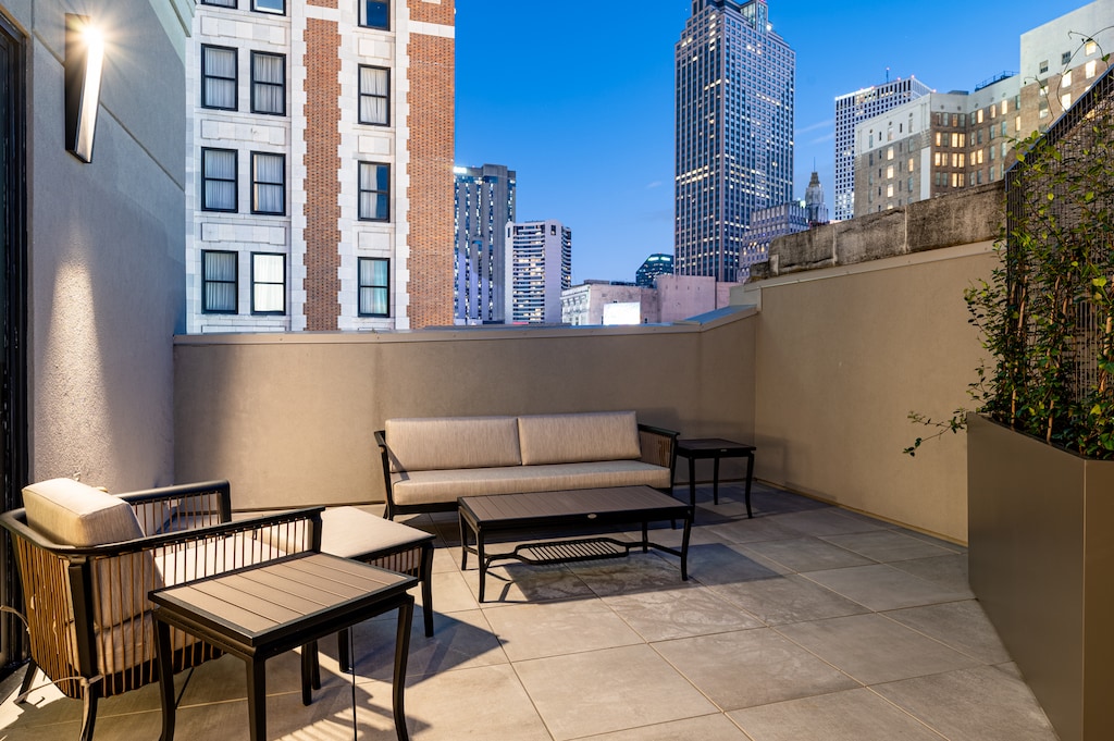 Unwind on this private patio under the night sky surrounded by the glow of city lights.