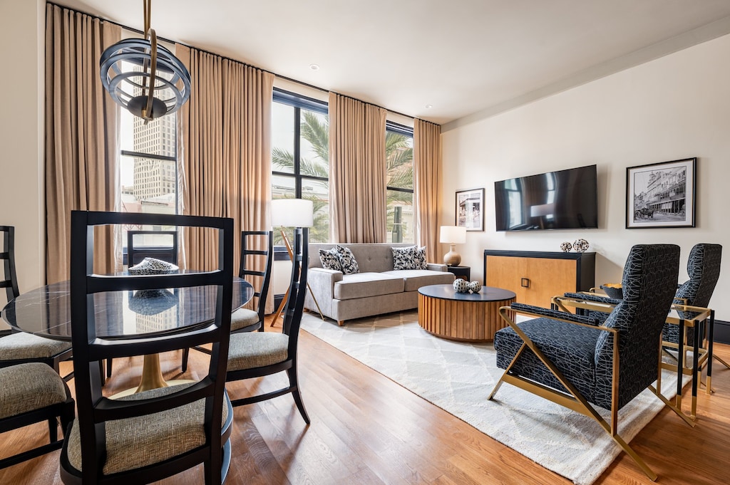 Living room 1 - Elegant living space overlooking Canal Street, framed by tall windows that flood the room with light and offer a vibrant cityscape view.