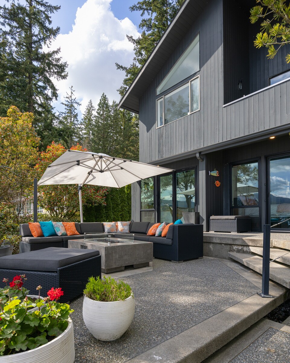 Gather with loved ones in this stylish patio space with comfy seating and forested mountain views.