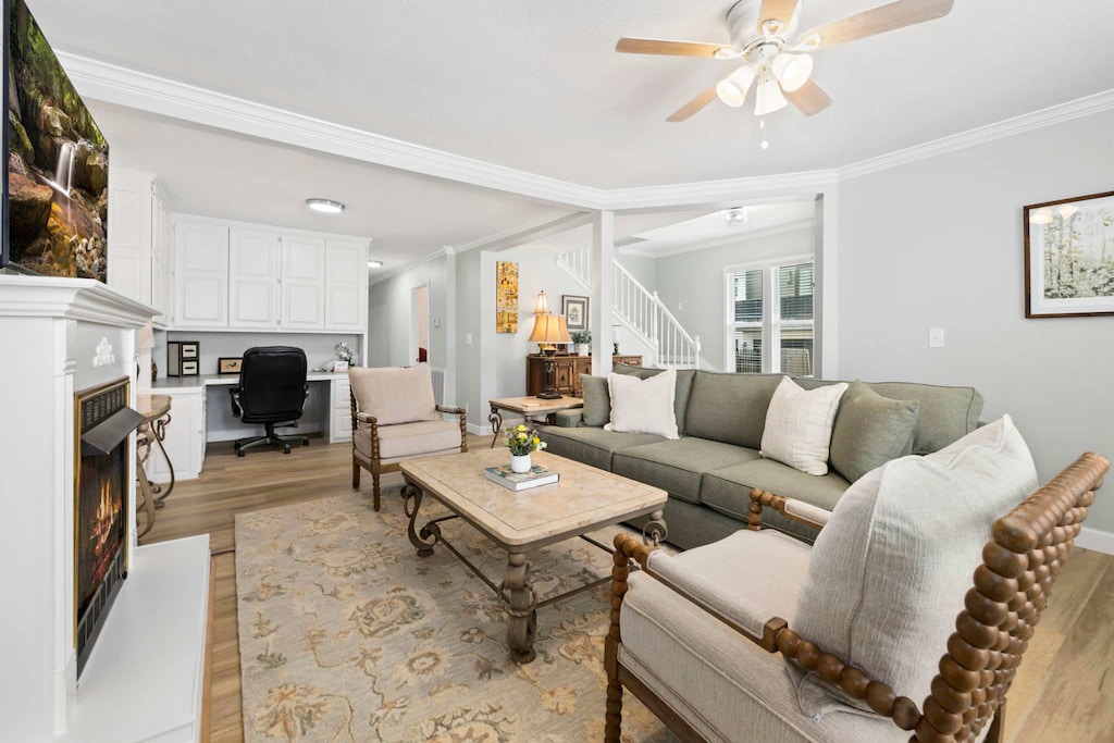 The living room features a large Smart TV with all your favorite streaming channels, along with plush seating, a fireplace, a selection of books, and a desk space. 