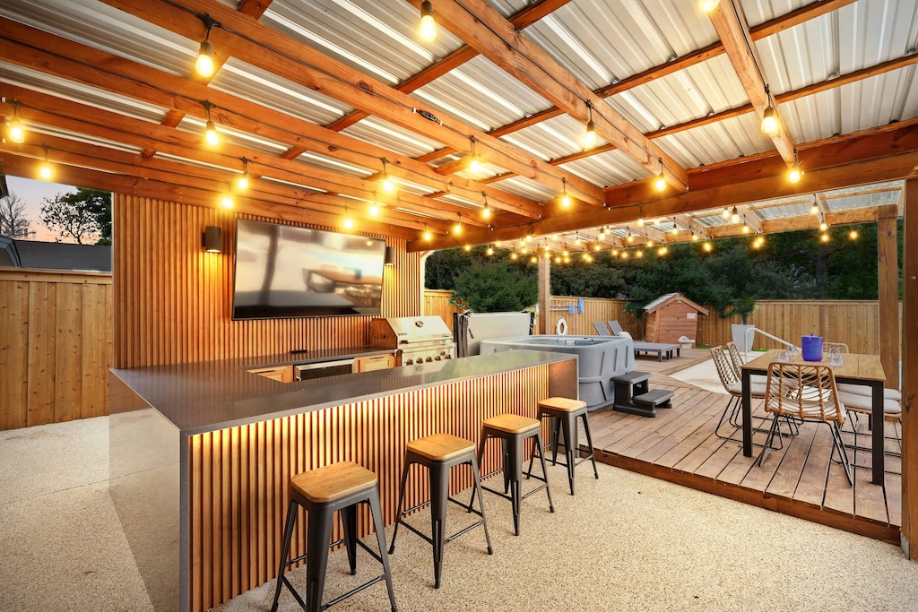 The indoor/outdoor lifestyle doesn’t get better than this! This outdoor bar comes fully decked out with a BBQ grill, outdoor TV, mini fridge, and bar-stool seating!