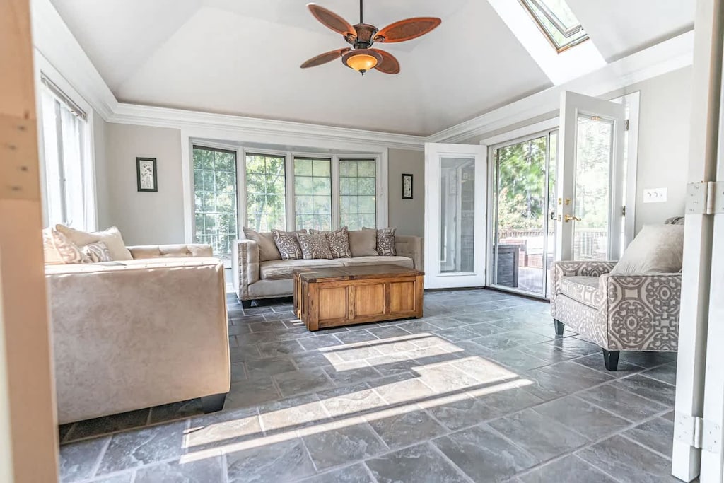 Sun room on main level that leads to a deck area with seating and a grill!