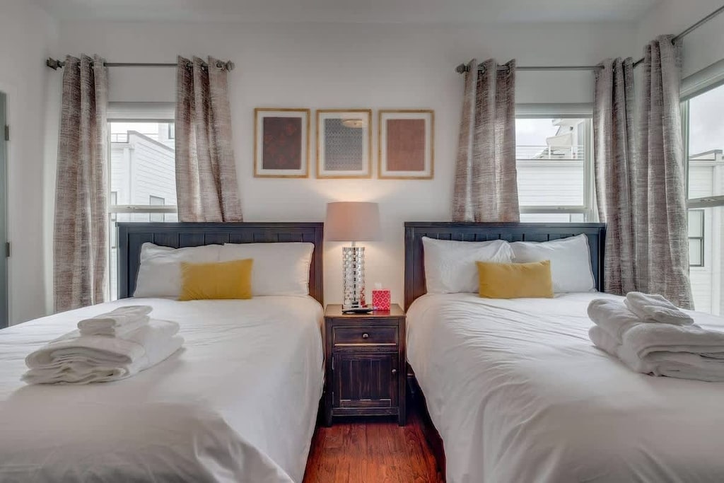 Bedroom 3 features two full beds and a private attached bathroom, perfect for families and group getaways.