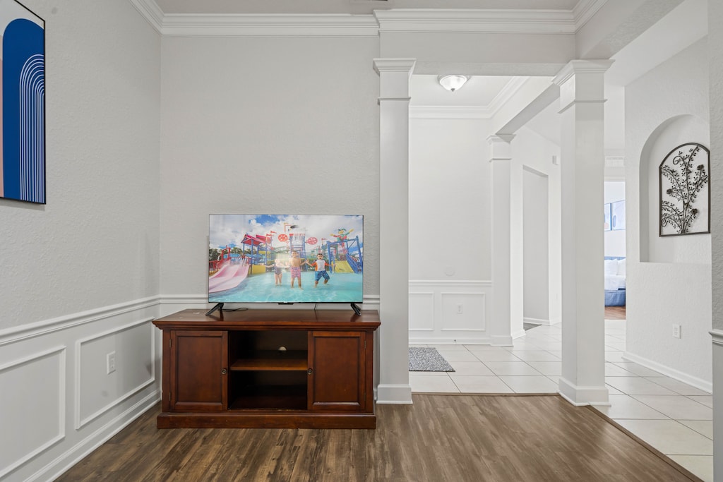- Entertainment corner with a smart TV & classic wooden console, perfect for family movie nights - Located in a beautifully designed space with elegant wainscoting & hardwood floors - Thoughtfully positioned for a cozy & immersive viewing experience