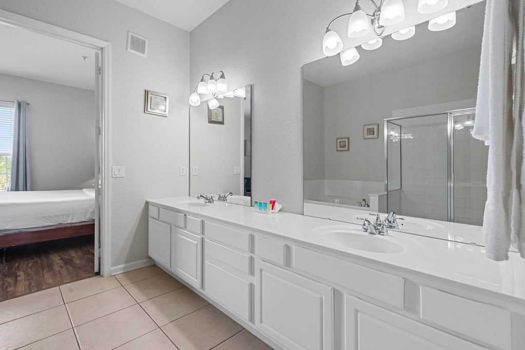 - Bathroom with a sleek double vanity & elegant lighting for a polished look - Spacious & functional, with plenty of room for getting ready in the morning or unwinding at night - Stylish & clean space, connected conveniently to the master bedroom