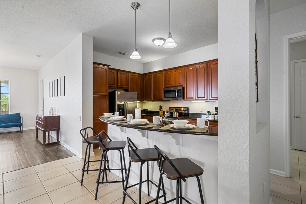 - Contemporary kitchen design with a focus on functionality and aesthetics - Breakfast bar setup creates a seamless flow into the living and dining areas - Welcoming space to gather, cook, and enjoy quality time together