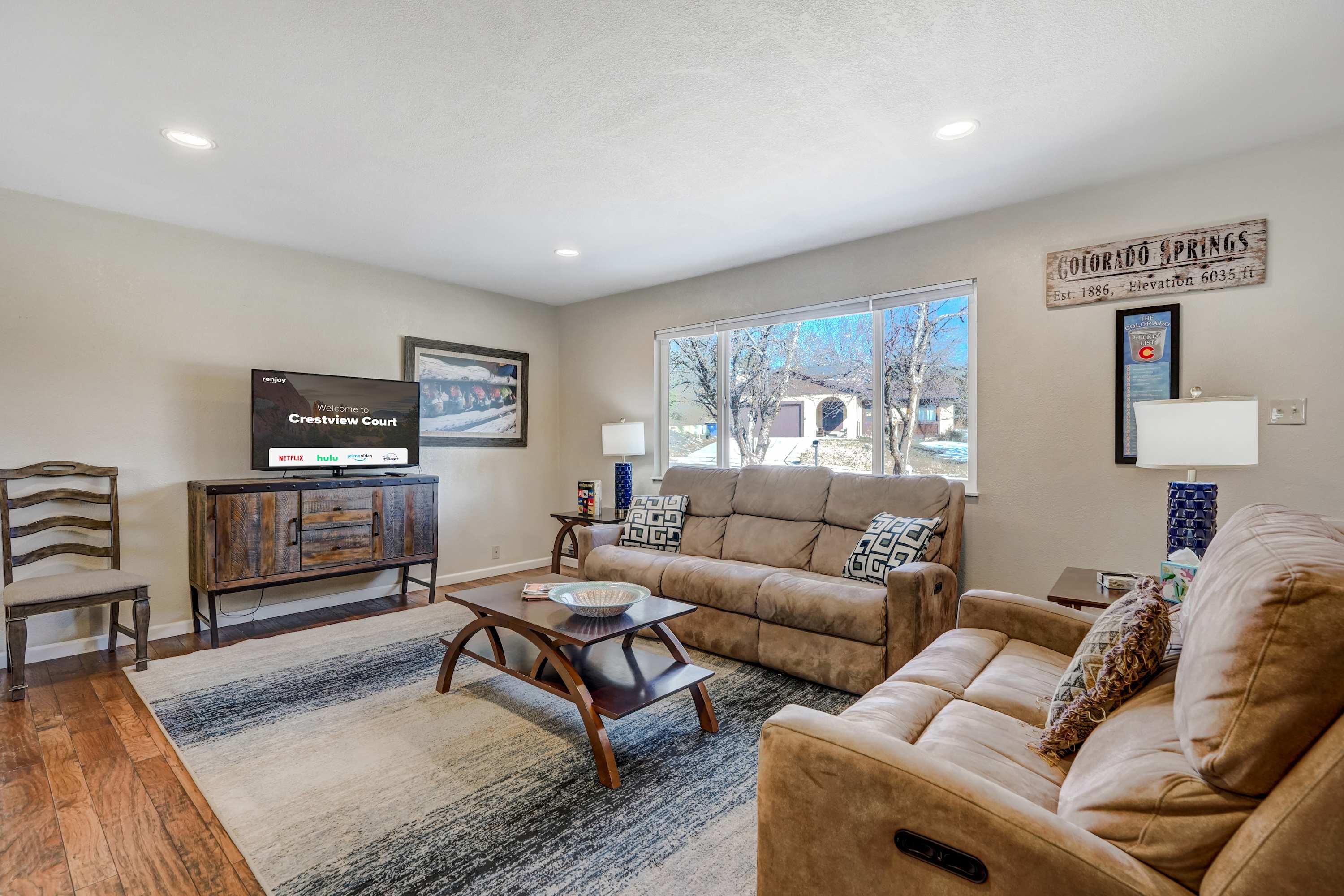 The main living room is bright and inviting, featuring plush seating, a large Smart TV, and a scenic view through the expansive window. Perfect for relaxing after a day of exploring! The main living room is bright and inviting, featuring plush seating, a large Smart TV, and a scenic view through the expansive window. Perfect for relaxing after a day of exploring!