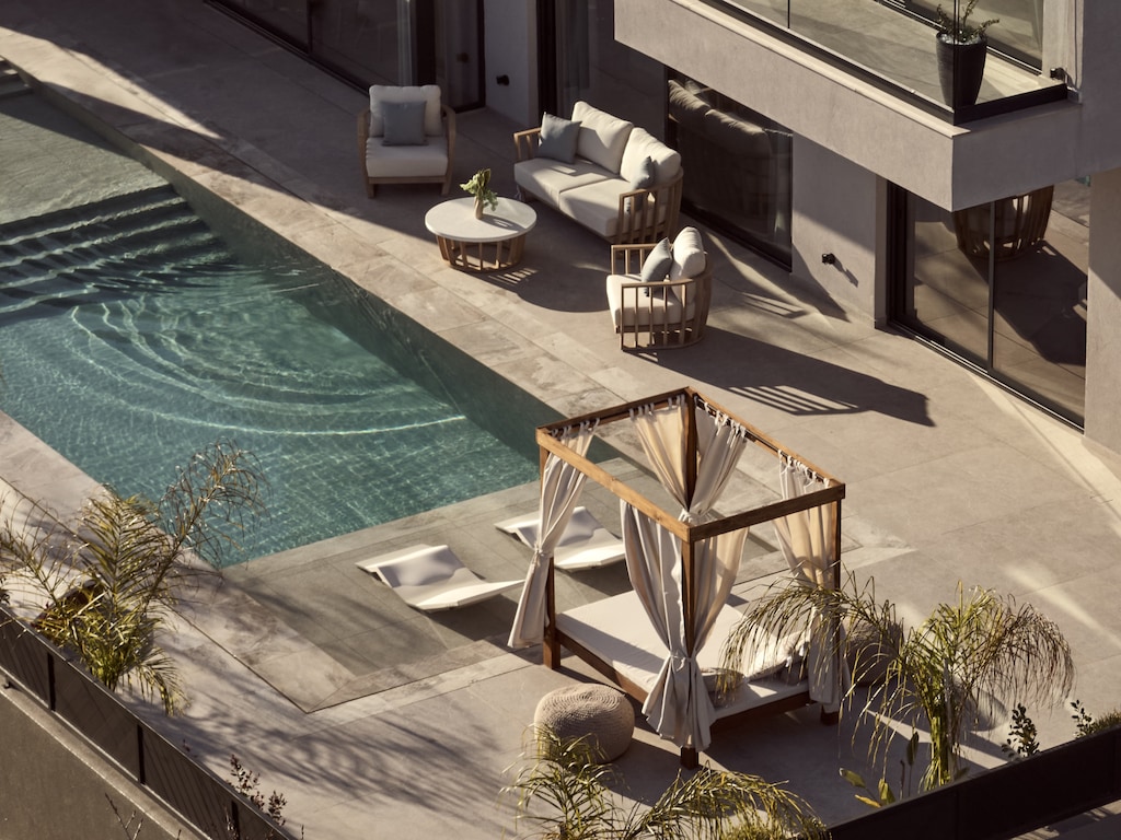 Cool off in crystal-clear waters framed by luxury loungers and lush surroundings