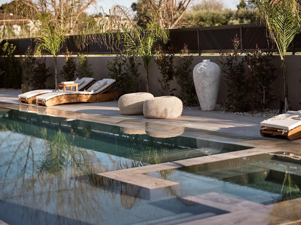 Sip, swim, and savor every moment by the pool which features hydromassage features.