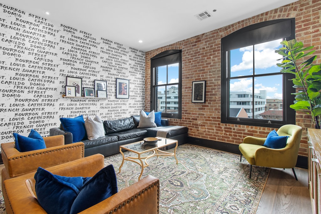 Relax in the living area with a smart TV, stylish seating, and a sleeper sofa for extra guests. Perfect for families or group stays in New Orleans, this inviting space is ideal for movie nights or recharging after a day in the city.