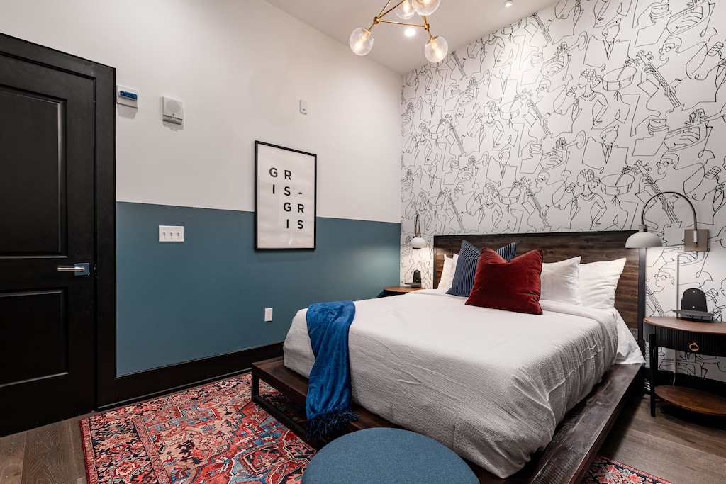 The second bedroom offers a cozy queen bed, dresser, smart TV, and soft linens. Great for families or friends traveling together, this room combines comfort and privacy in the heart of Downtown New Orleans.