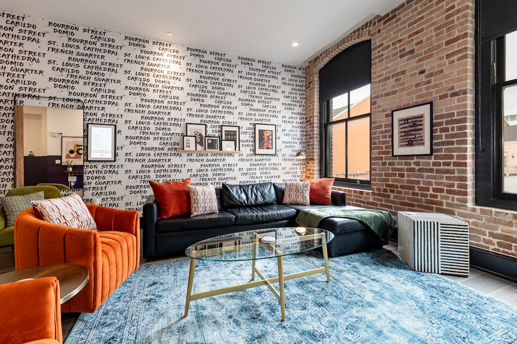 Relax in the living area with a smart TV, stylish seating, and a queen-sized sleeper sofa for extra guests. Perfect for families or group stays in New Orleans, this inviting space is ideal for movie nights or recharging after a day in the city.