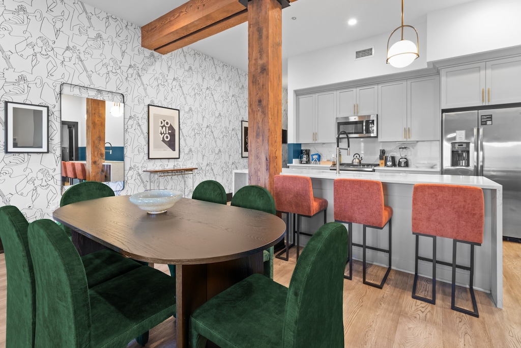 Enjoy meals together at your in-suite dining table with seating for your group. Whether it's takeout, delivery, or a home-cooked meal, this cozy dining area makes every stay at 888 Baronne feel like home in New Orleans.