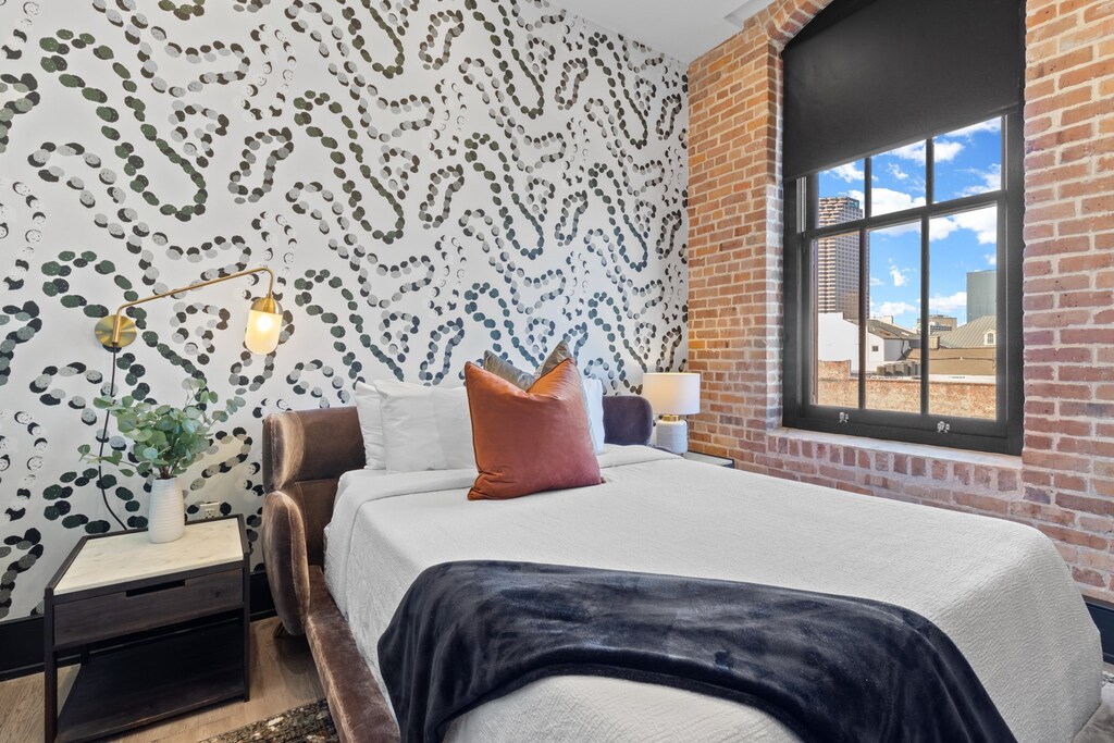 The second bedroom offers a cozy queen bed, dresser, smart TV, and soft linens. Great for families or friends traveling together, this room combines comfort and privacy in the heart of Downtown New Orleans.