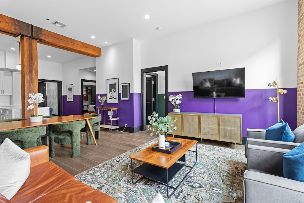 Relax in the living area with a smart TV, stylish seating, and a sleeper sofa for extra guests. Perfect for families or group stays in New Orleans, this inviting space is ideal for movie nights or recharging after a day in the city.