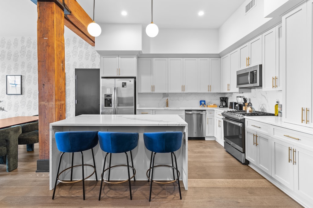 Cook or snack in style with a full kitchen featuring GE stainless appliances, cookware, and an island with bar seating. Ideal for short or extended stays, our kitchens make group travel in New Orleans easy and comfortable.