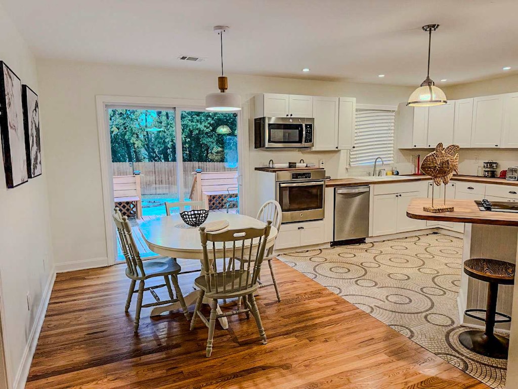 Spacious kitchen with modern appliances and a cozy dining area, perfect for family gatherings and meals.
