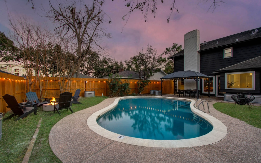 Welcome to a backyard oasis! Beautifully landscaped for a resort-like feel, take a dip in the pool, settle in around the cozy fire pit, or enjoy an al fresco dinner on the patio.