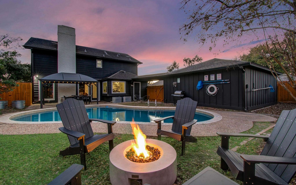 Beautifully landscaped for a resort-like feel, this amazing backyard features an outdoor swimming pool, a furnished patio, outdoor seating, and a cozy fire pit!