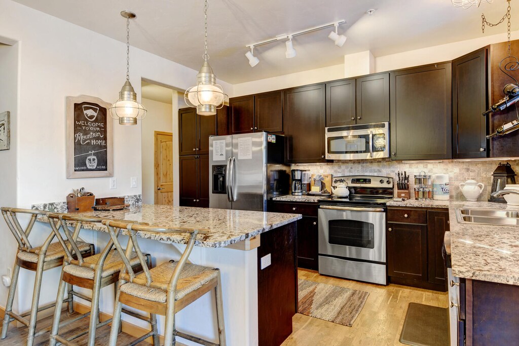 Fully Equipped Chef's Kitchen with Large Bar That Seats 3