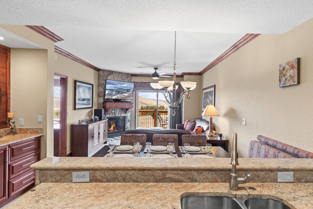 Gather around your elegant dining table while the fireplace creates a cozy ambiance.