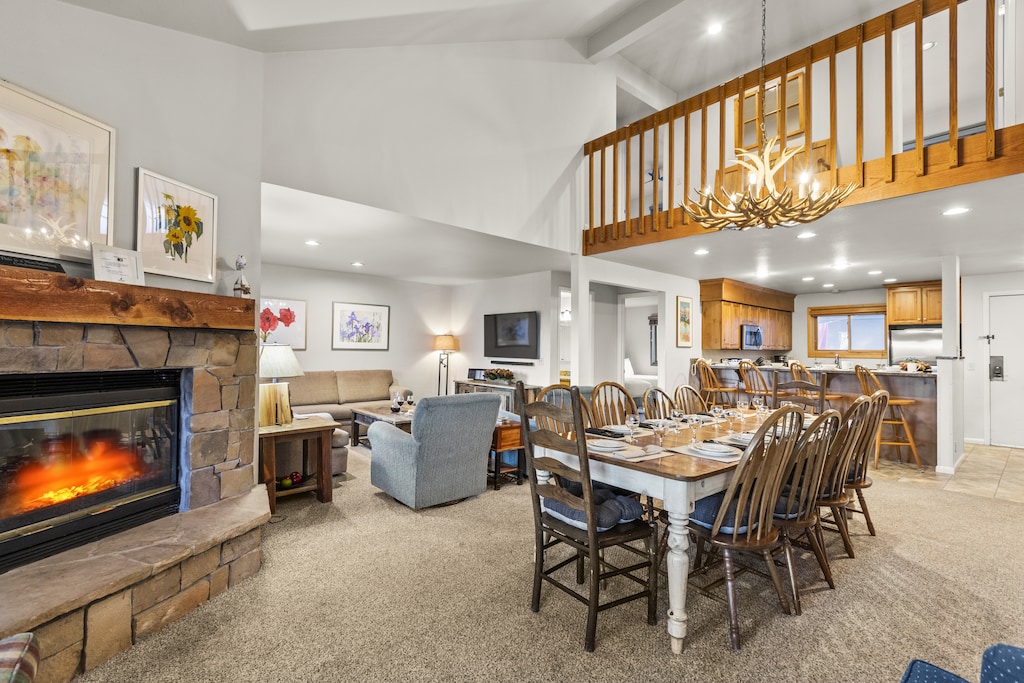 The open concept living, dining, and kitchen area with a gas burning fireplace.