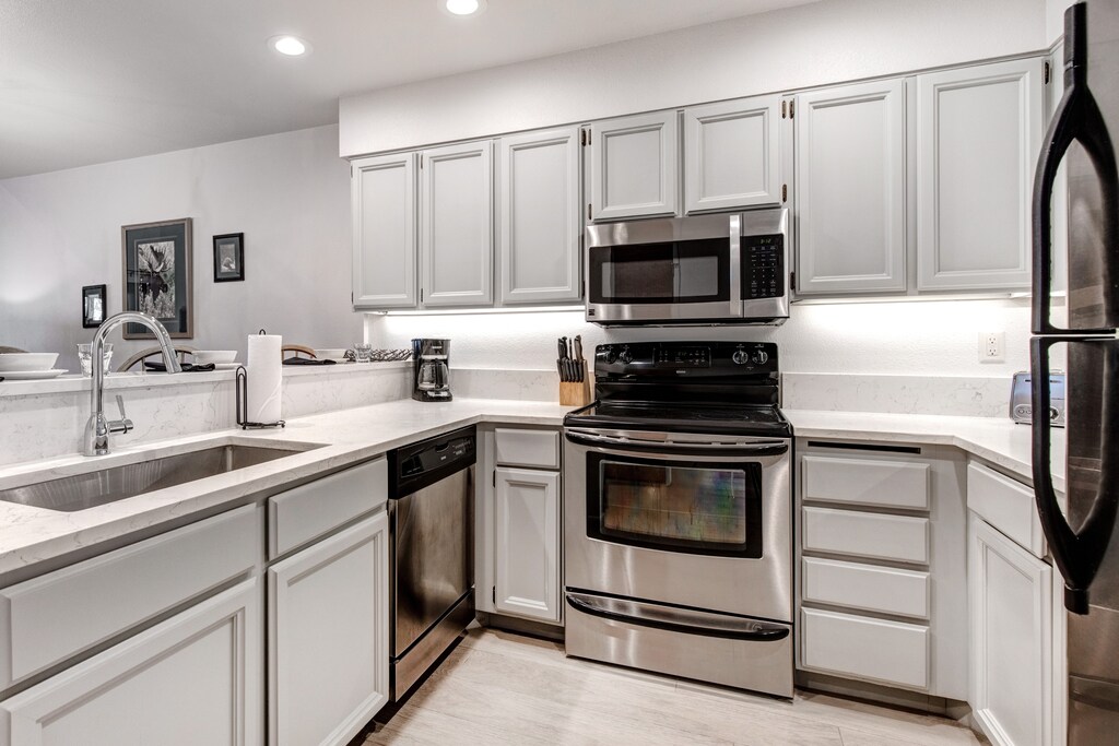 Snow Flower 152 has a well equipped kitchen with grey cabinets and stainless steel appliances.