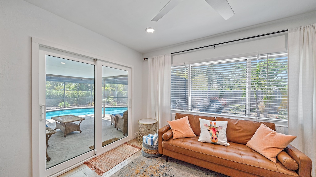 Enjoy seamless indoor-outdoor living from this second seating area with direct sliding door access to your private, screened-in pool and lanai.
