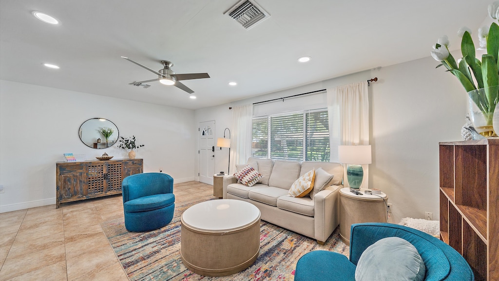 The main living area welcomes you with bright light, comfortable seating, and vibrant coastal decor, creating a stylish retreat after exploring Sarasota.