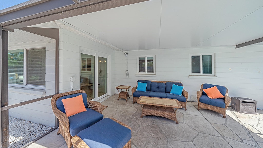 Enjoy the cool shade and comfortable patio furniture under the covered lanai, offering a relaxed spot right next to the private pool area.
