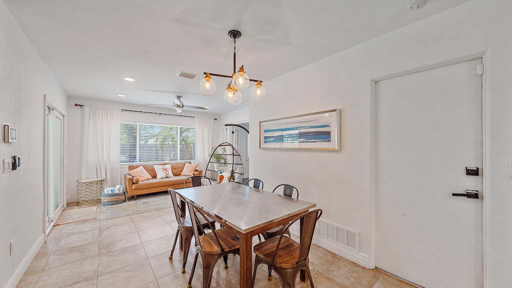 Gather for meals at the stylish dining table under a unique light fixture, perfectly positioned between the main living space and the second sitting area with access to the private pool.