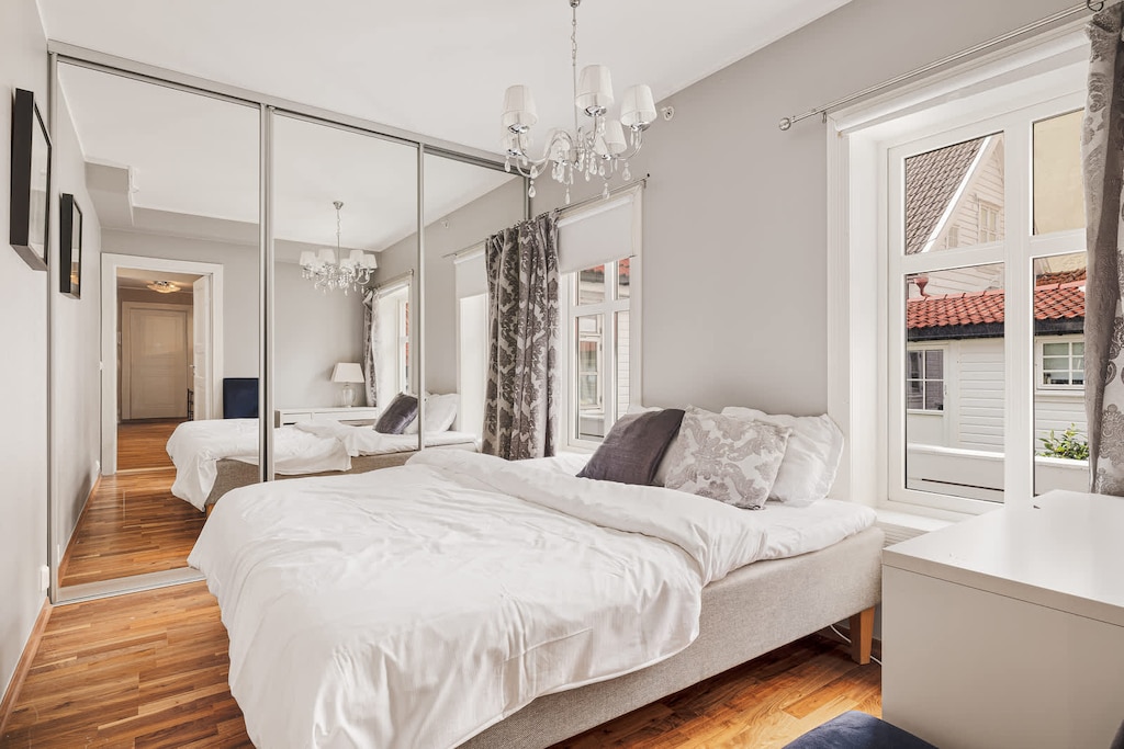 A serene bedroom, bathed in natural light, showcasing a comfortable bed and elegant decor.