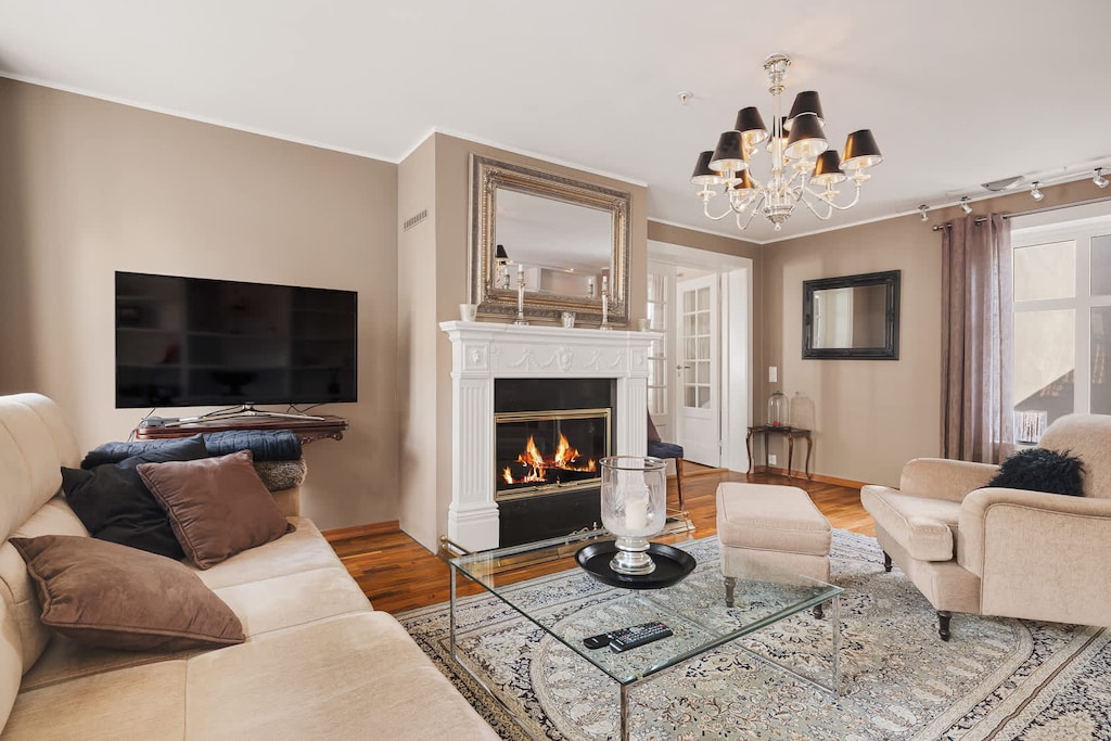 Cozy up in your dream living room! Imagine the warmth of the fireplace and the comfort of the couch.
